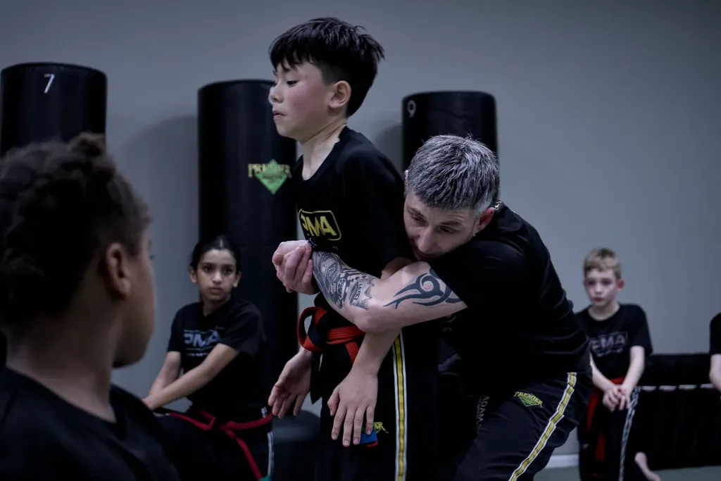An instructor correcting a child's guard position