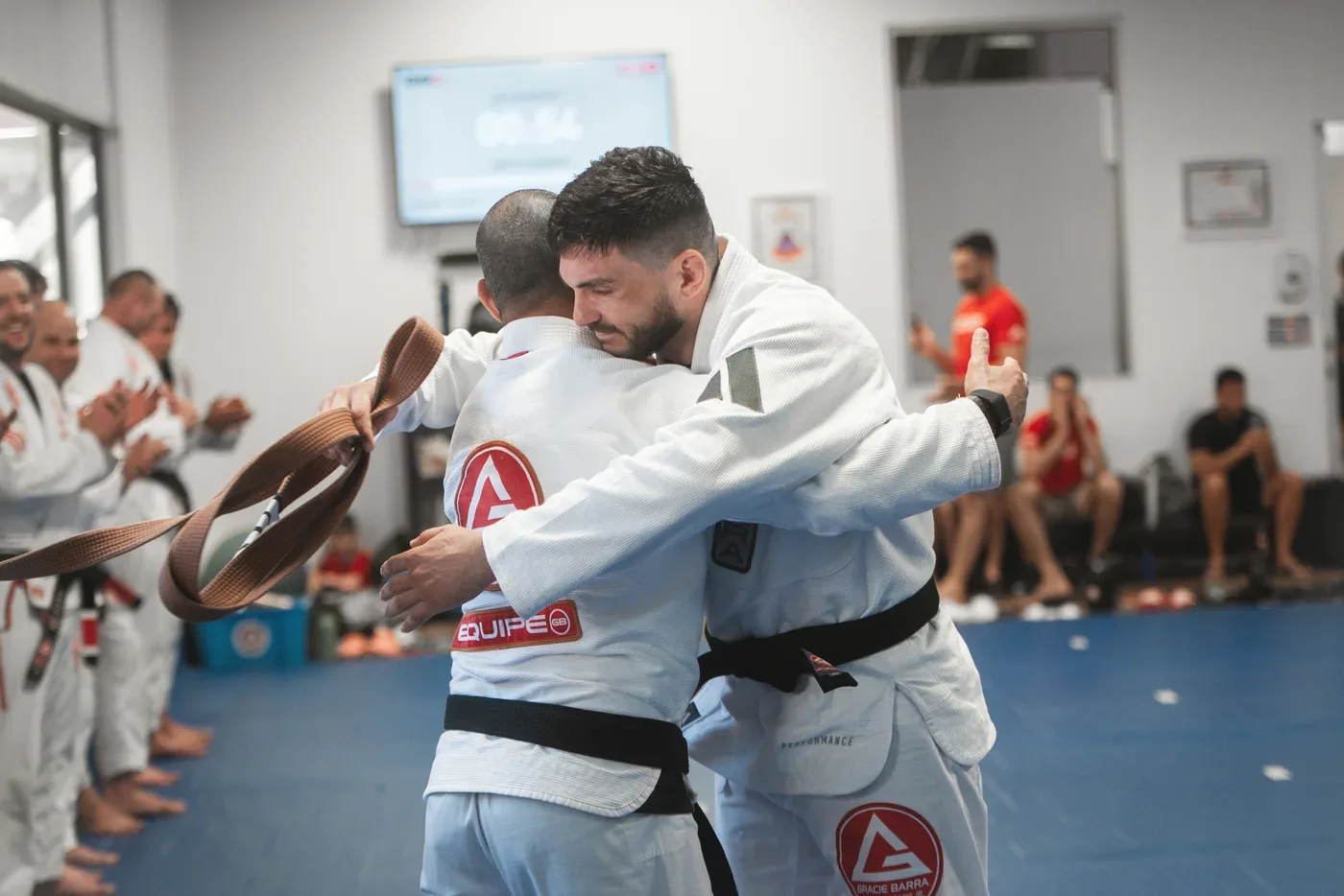 A member being awarded a new belt at Gracie Barra